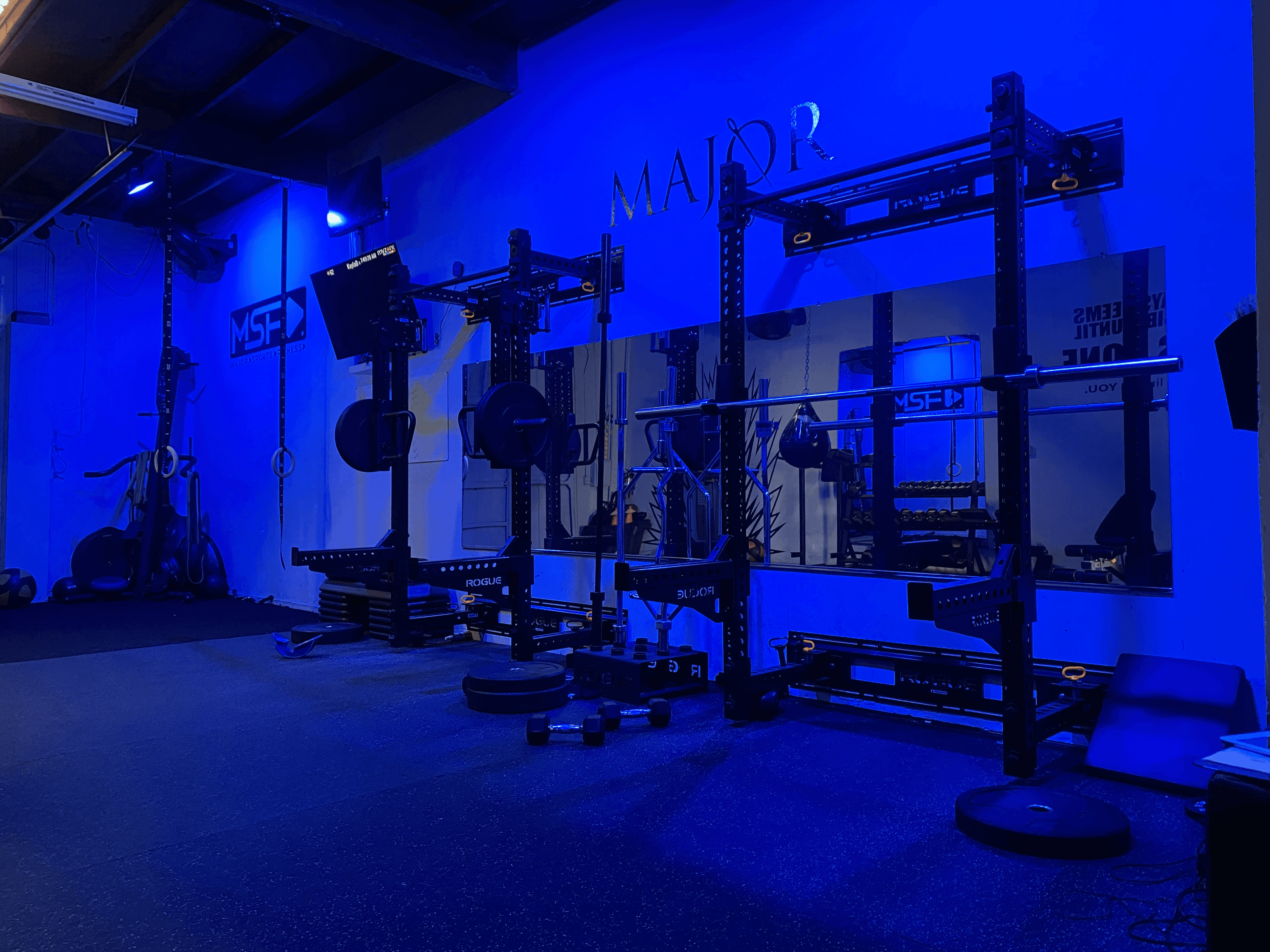 Off The Grid Fit studio in Santa Ana, CA — squat rack and mirrors.